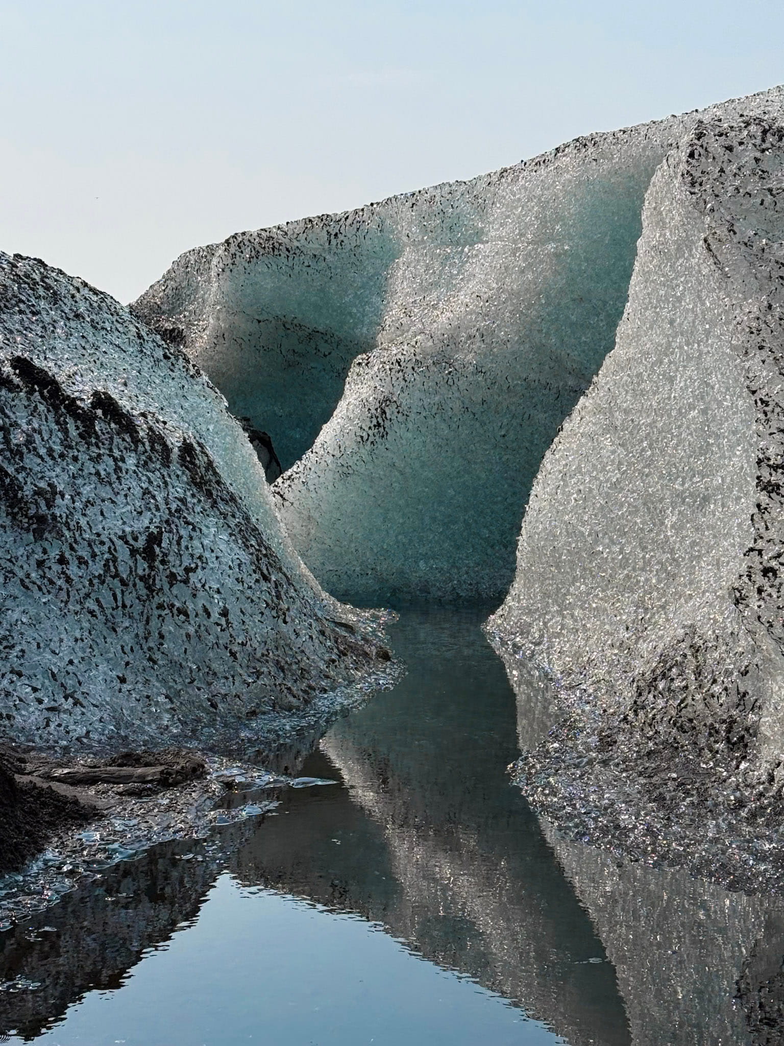 blue glacial ice with black volcanic ash deposits